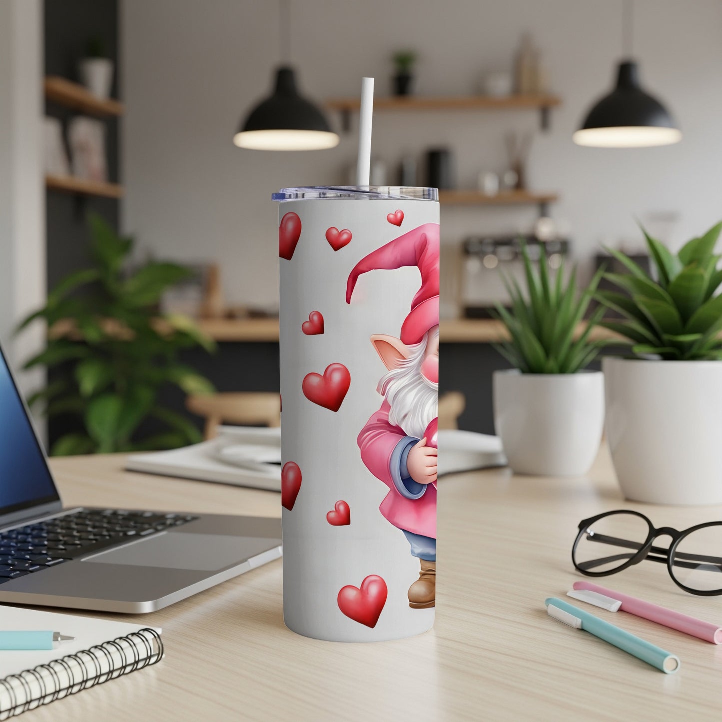 White tumbler with gnome and red hearts, straw inserted.