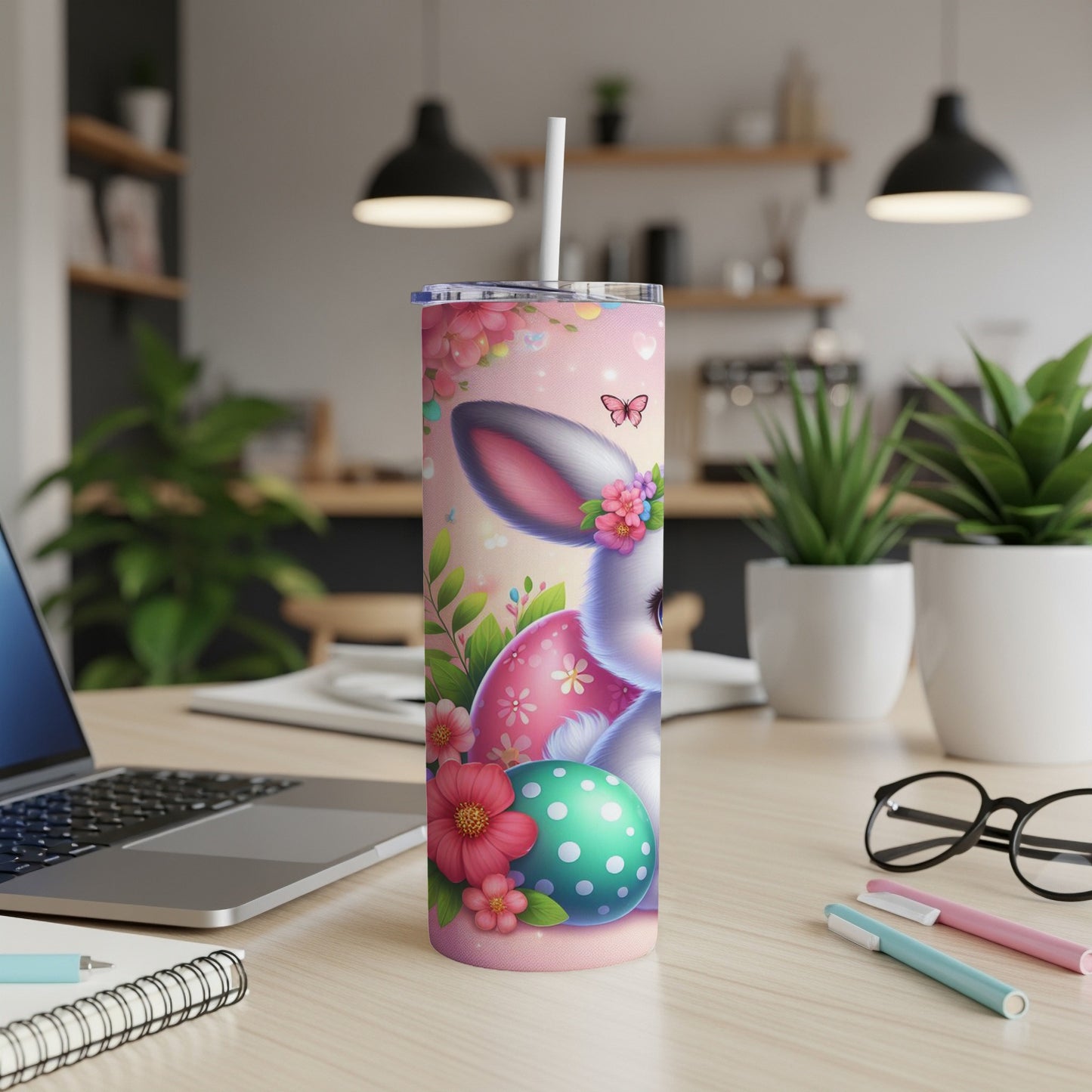 Easter bunny with decorated egg and flowers on a tumbler.