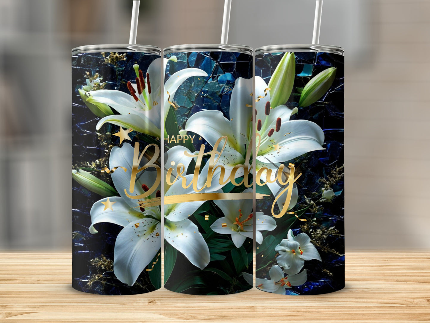 Birthday tumbler with white lilies and gold accents on a wooden surface.