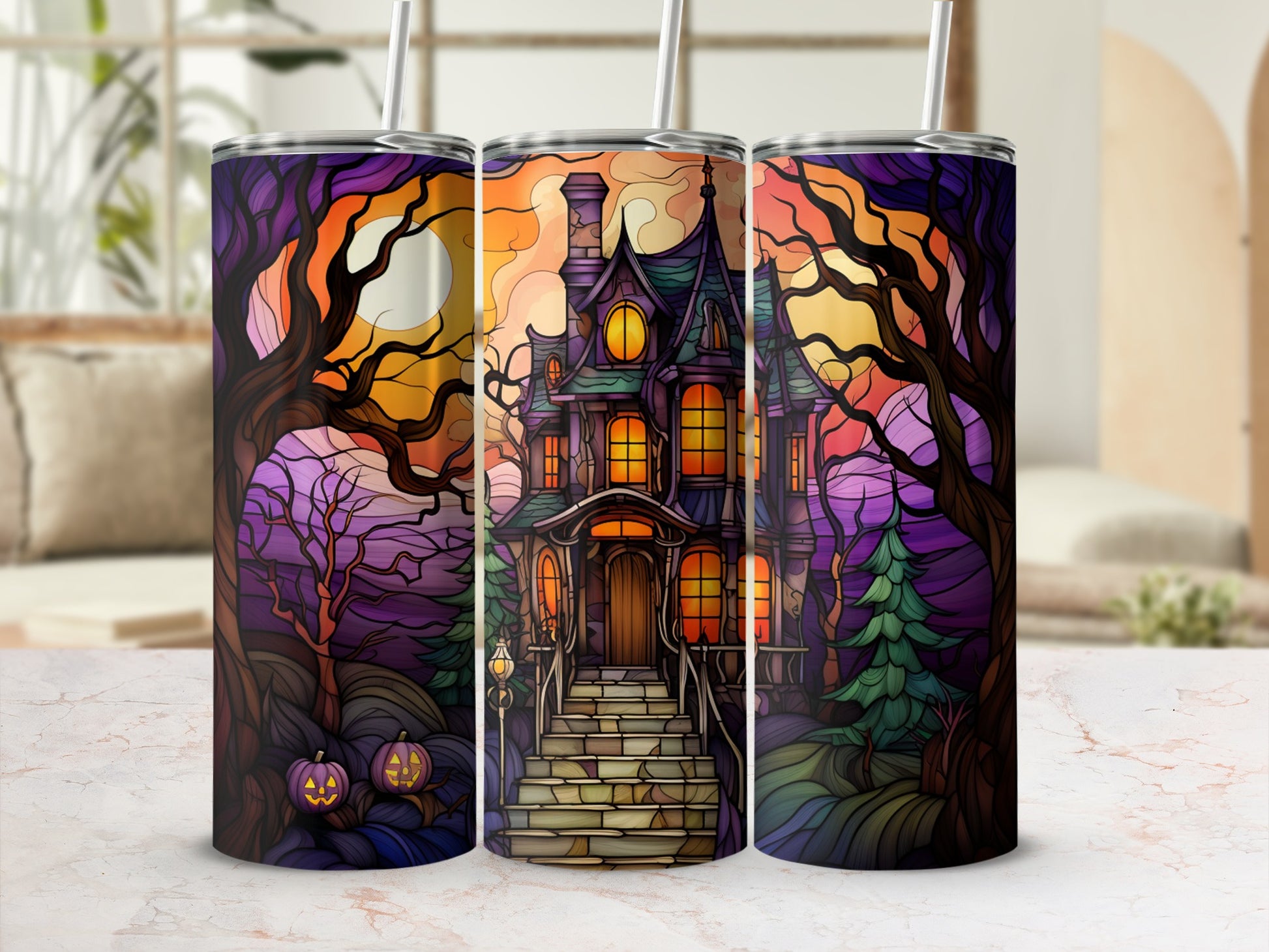 Spooky haunted house with pumpkins and stained glass tree art on a tumbler.