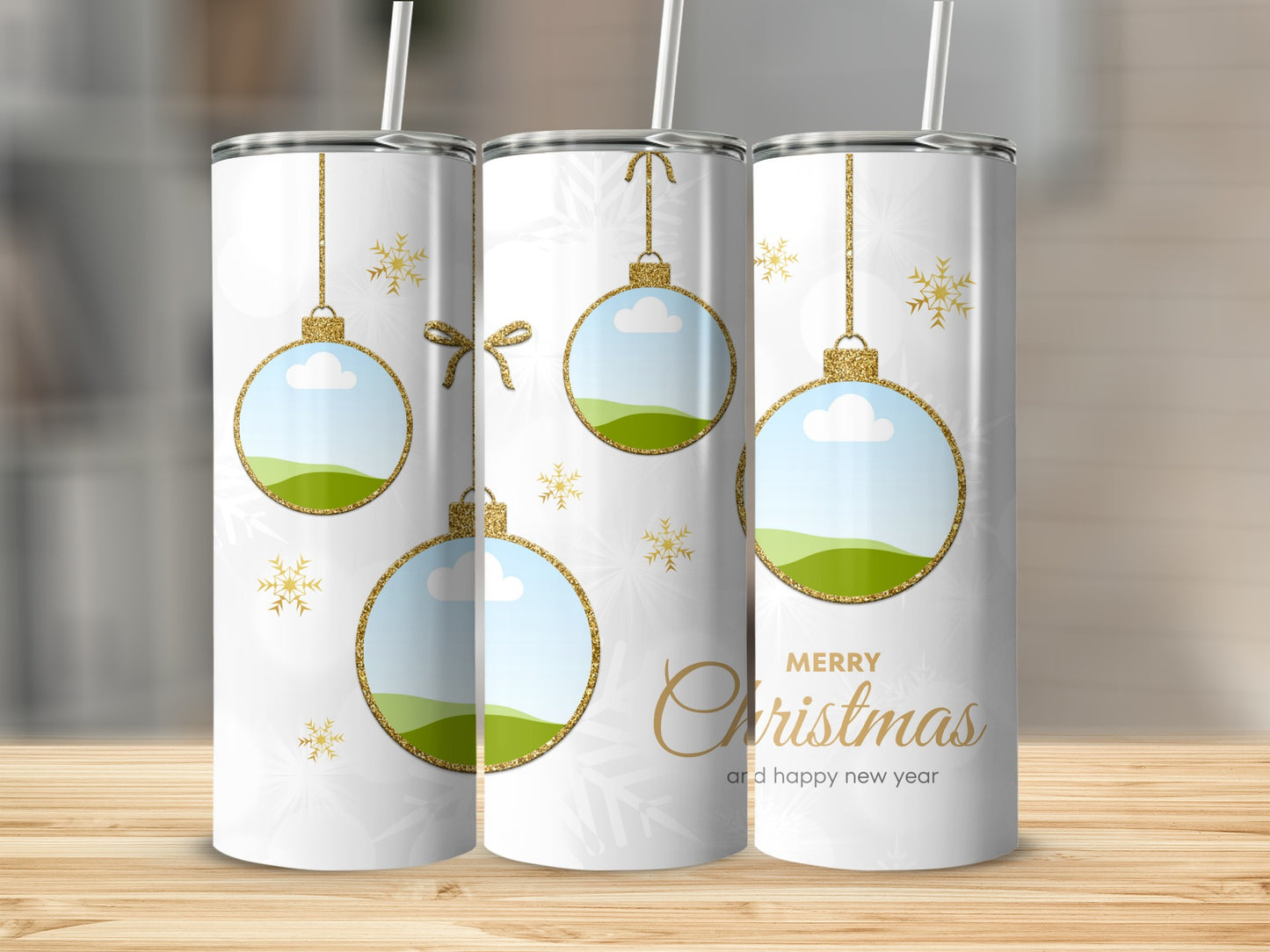 White tumblers with gold glitter Christmas ornaments and snowflakes.