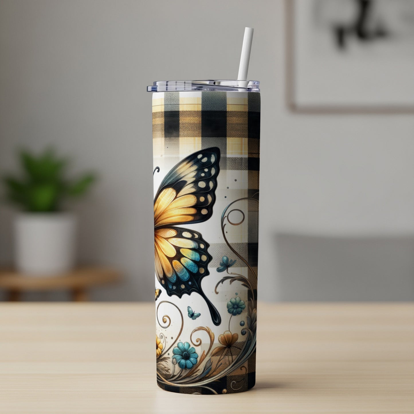 Tall tumbler with butterfly and floral design on plaid background.