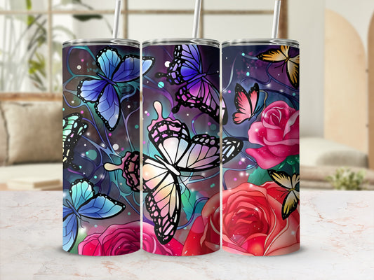 Three tumblers with butterfly and rose floral designs on a marbled surface.
