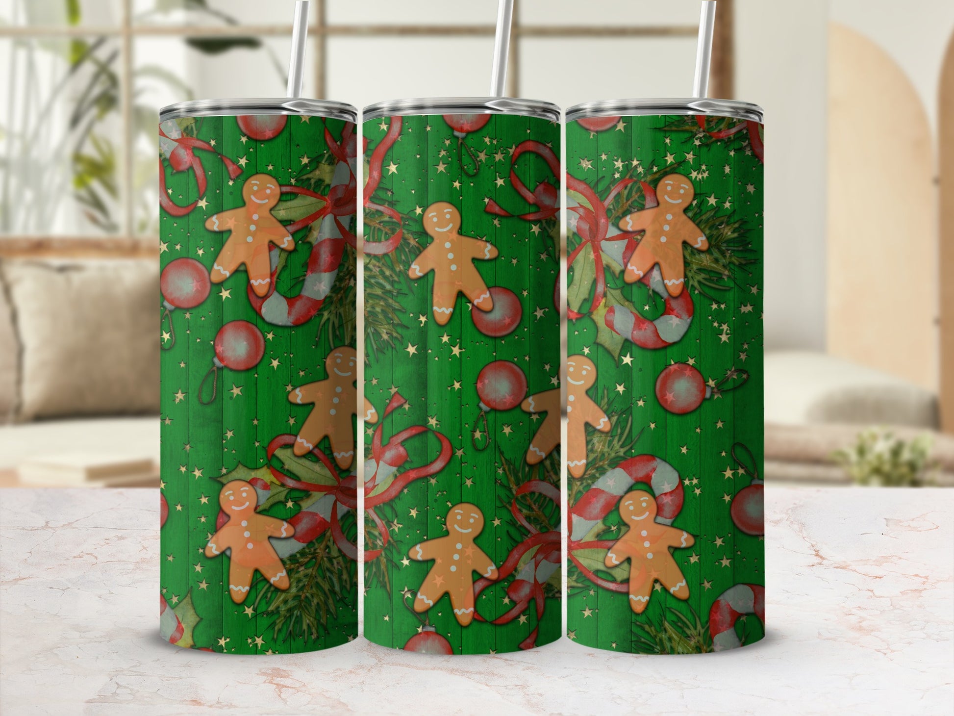 Three green tumblers with gingerbread men, candy canes, and ornaments pattern.