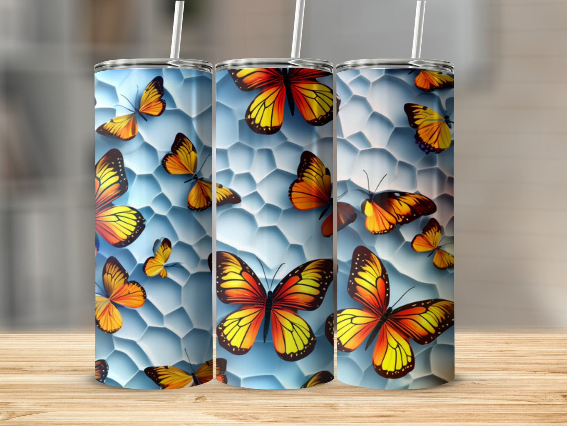 Three tumblers with a vibrant butterfly and honeycomb pattern.