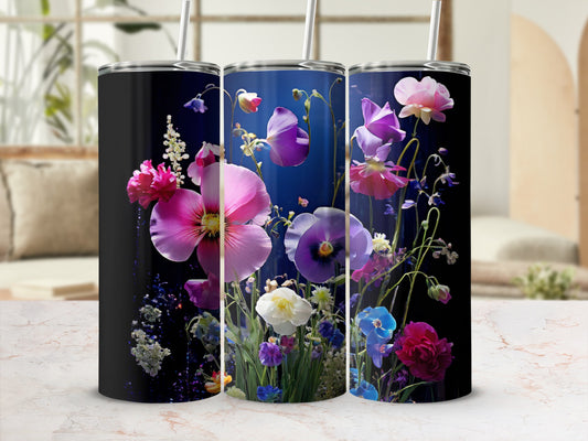 Three tumblers with vibrant floral designs on a marble surface.