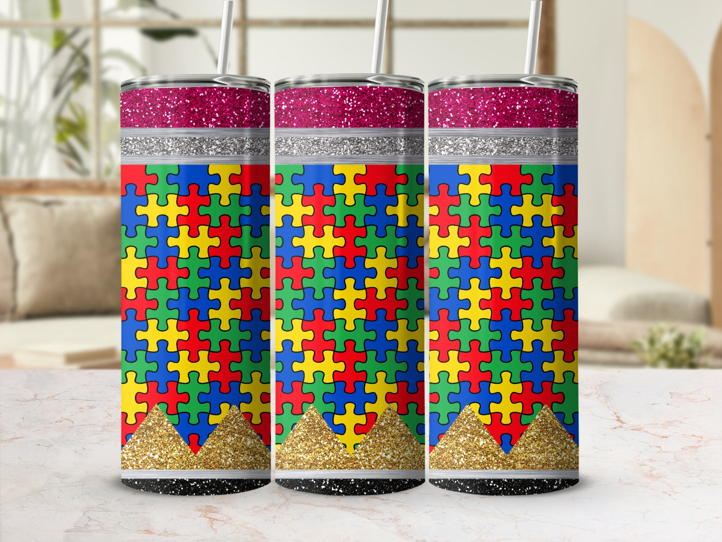 Three tumblers with autism puzzle print and glitter accents.