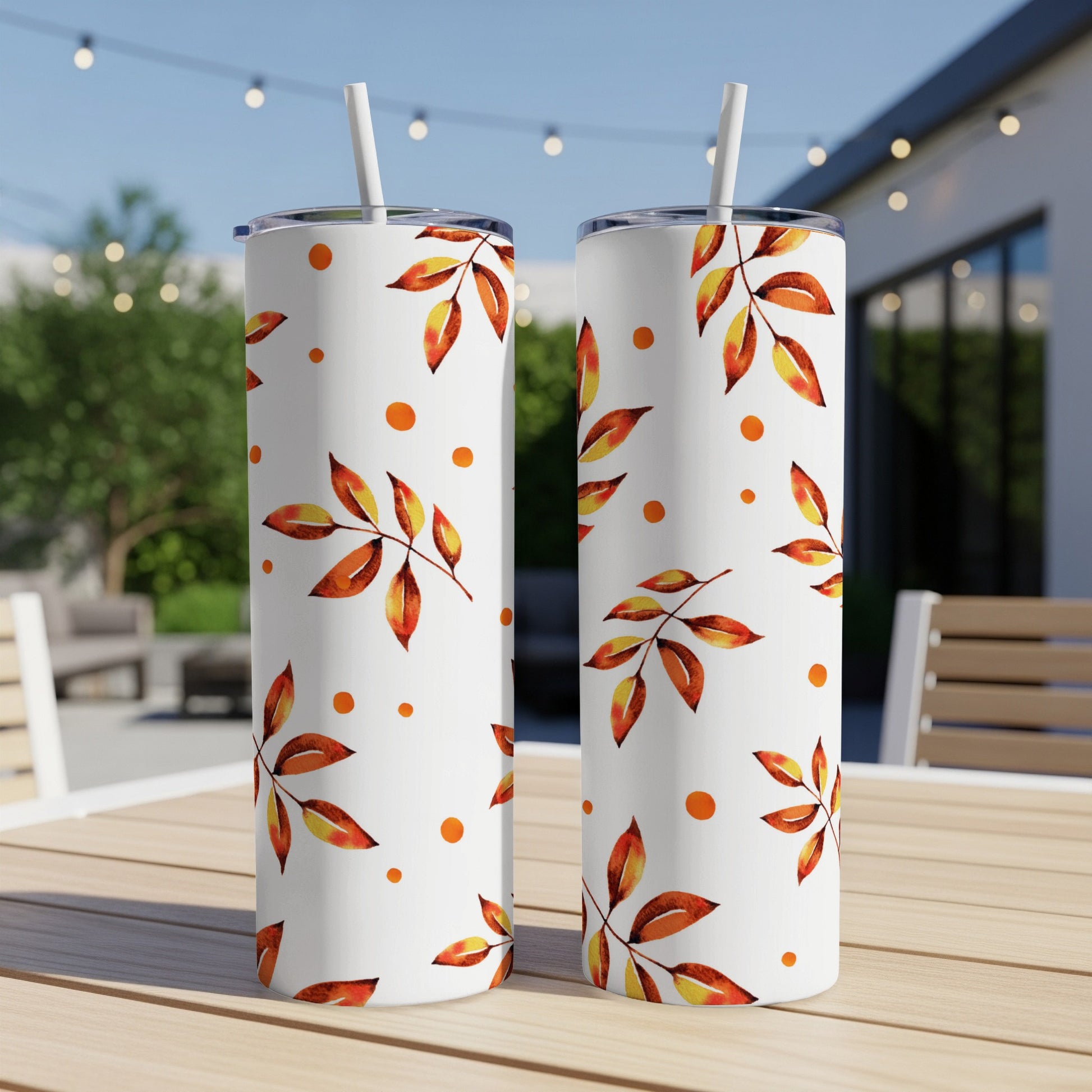 Two white tumblers with autumn leaves and polka dot pattern.