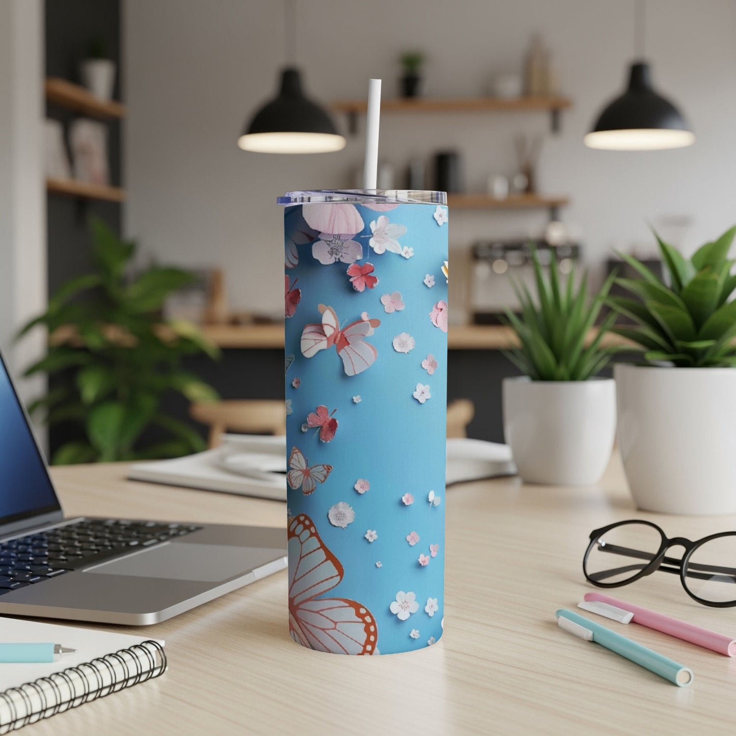 Blue tumbler with butterflies and flowers, white straw.