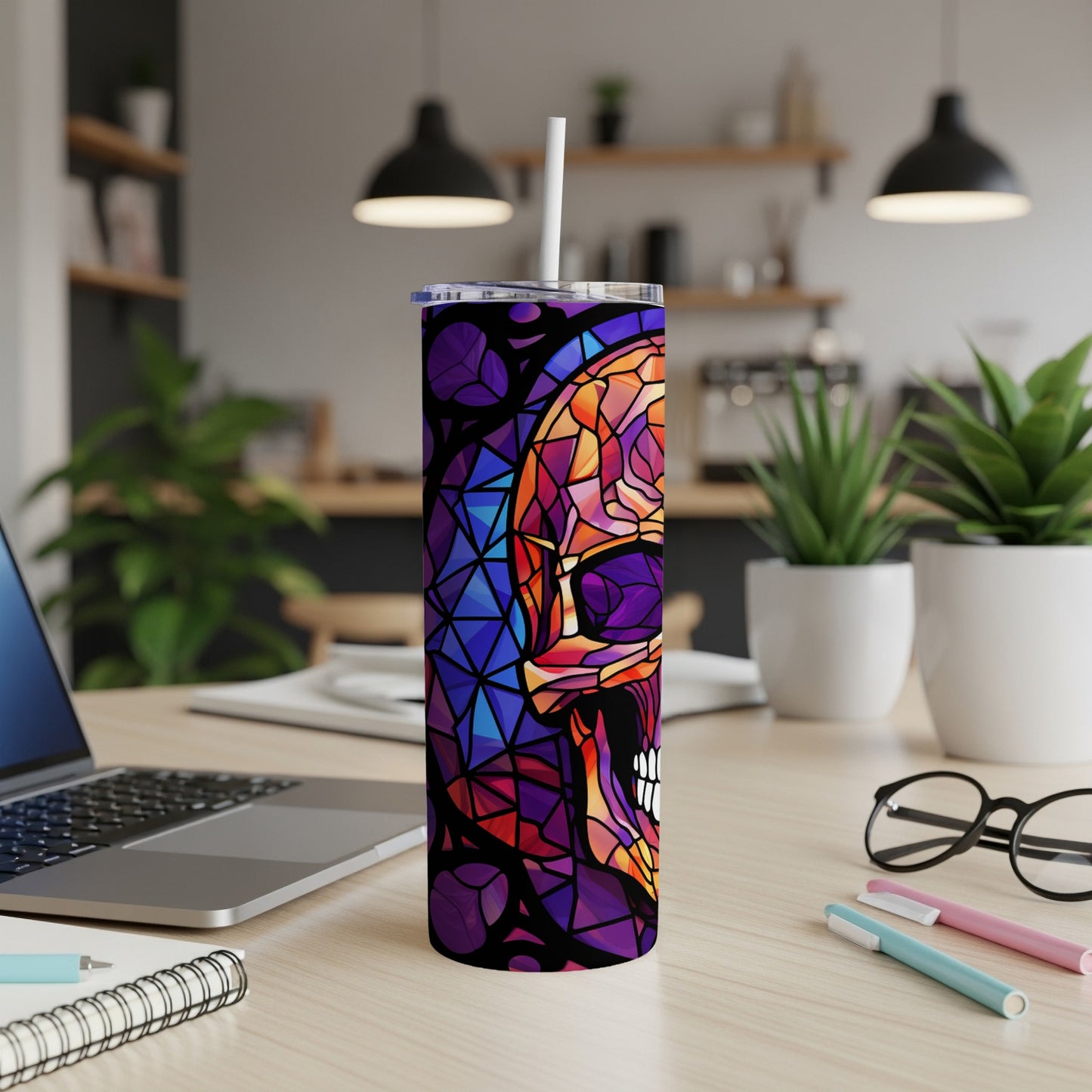 Stained glass skull design on a white insulated tumbler with a straw.