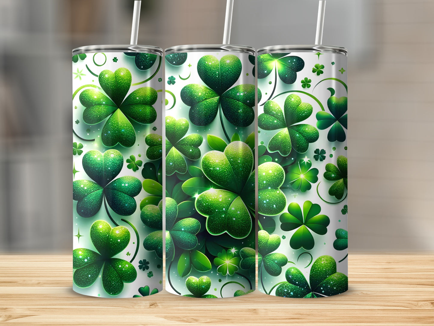Three green shamrock patterned tumblers with straws on a wooden surface.