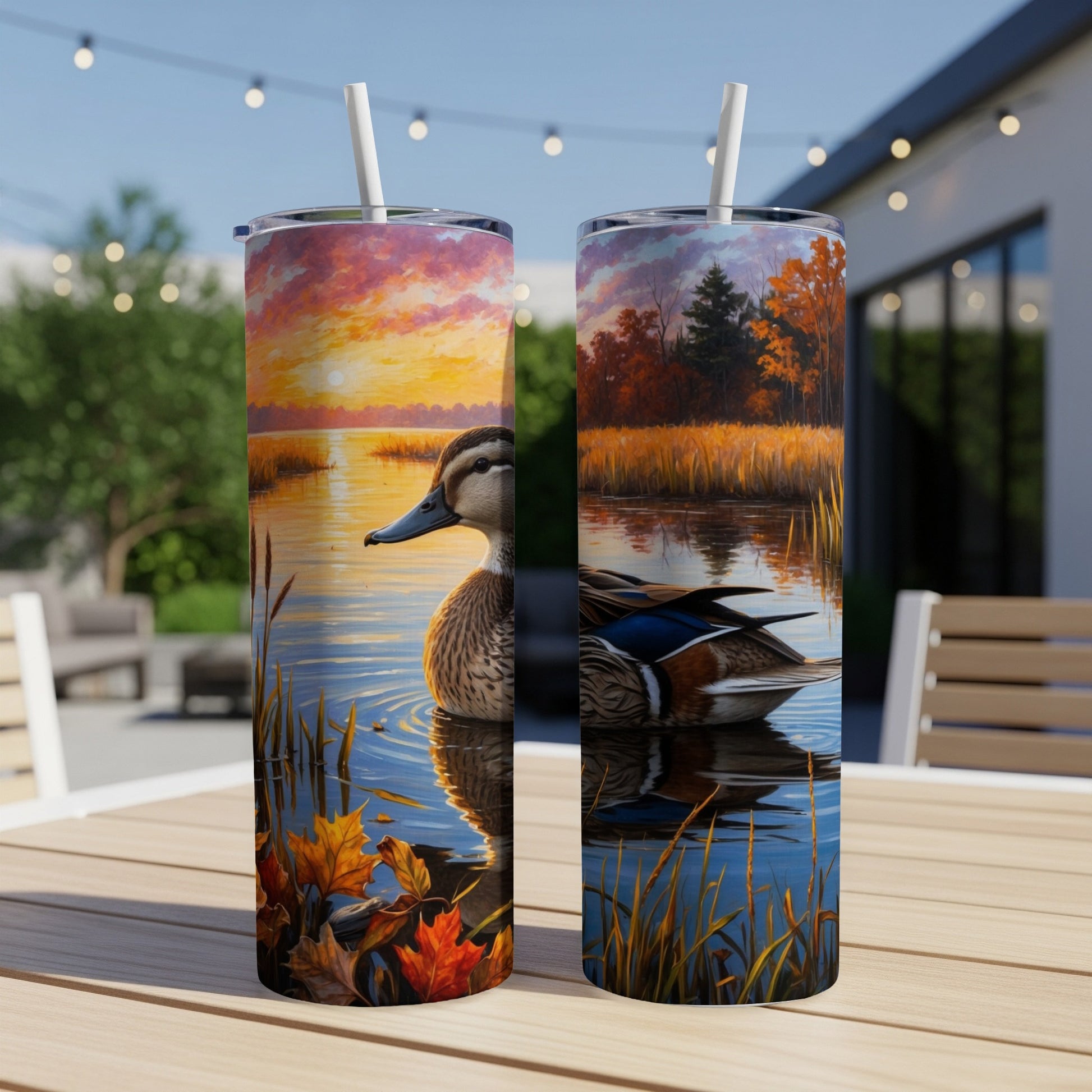 Two tumblers with a sunset duck and fall foliage scene.