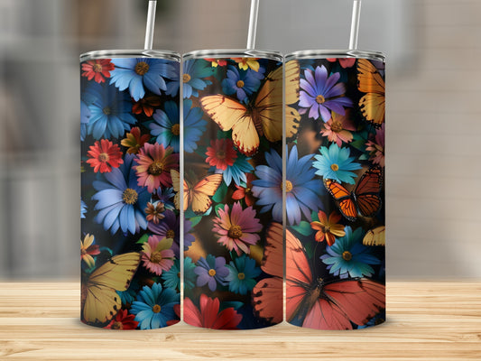 Tumblers with colorful flowers and butterflies, on a wooden surface.