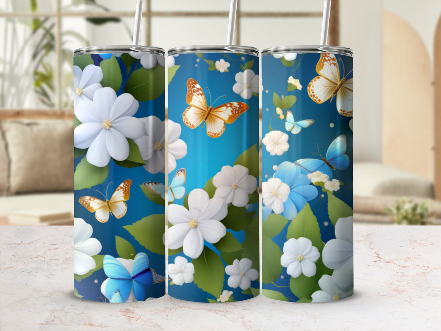 Three tumblers with blue background, white flowers, and butterflies.