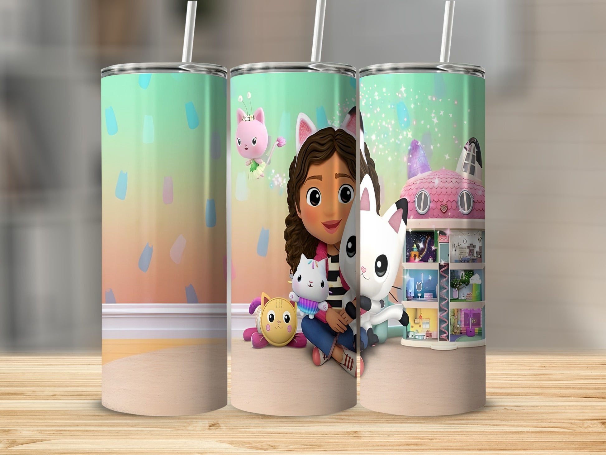 Gabby's Dollhouse characters and cat-themed house on a patterned tumbler.
