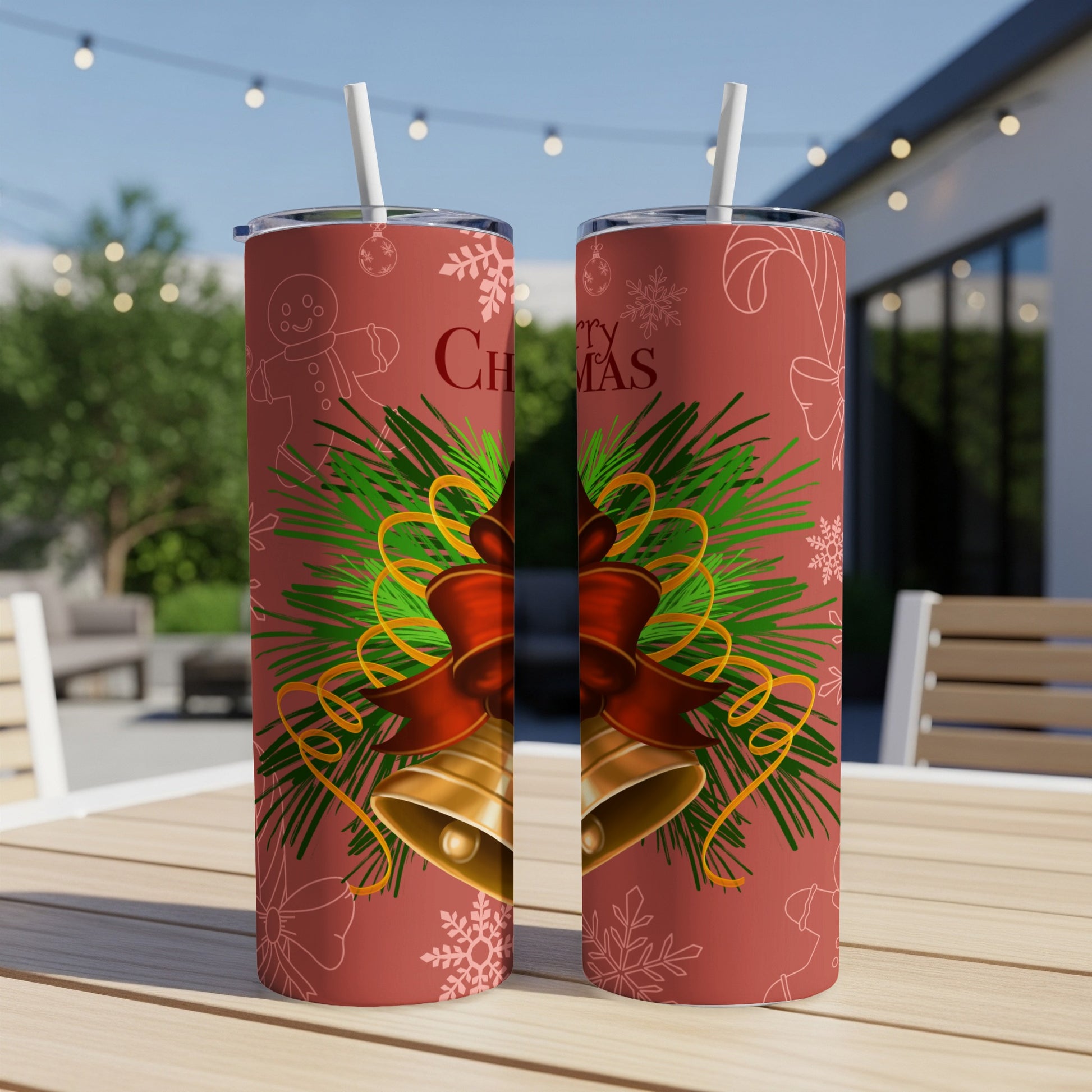Red tumbler with Christmas bells, pine, and bow.