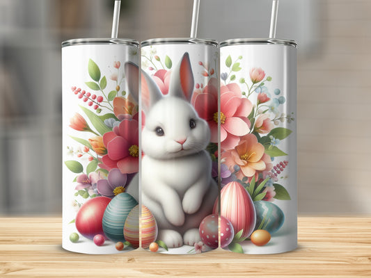 White bunny with Easter eggs and flowers on a tumbler.