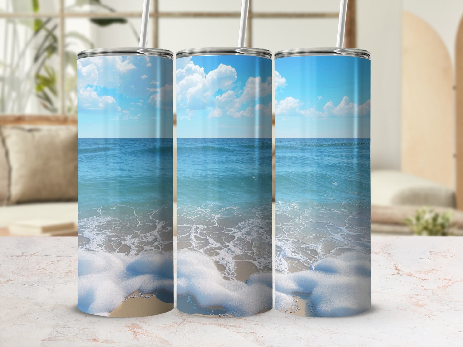 Three tumblers with ocean waves and beach scene design.