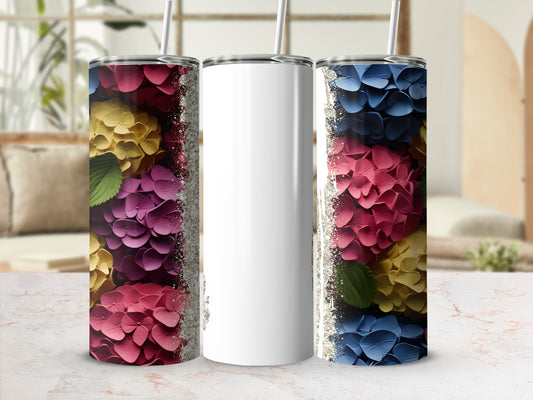 Two floral tumblers with glitter accents flank a blank white tumbler.