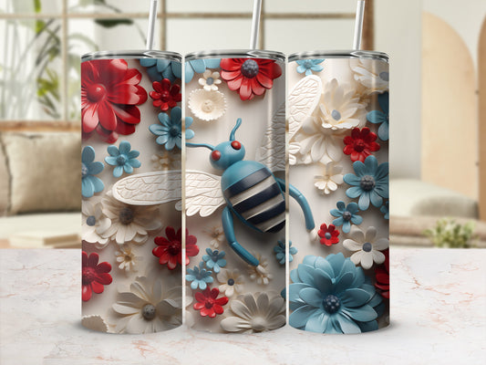 Tumbler with blue bee surrounded by red and white flowers.
