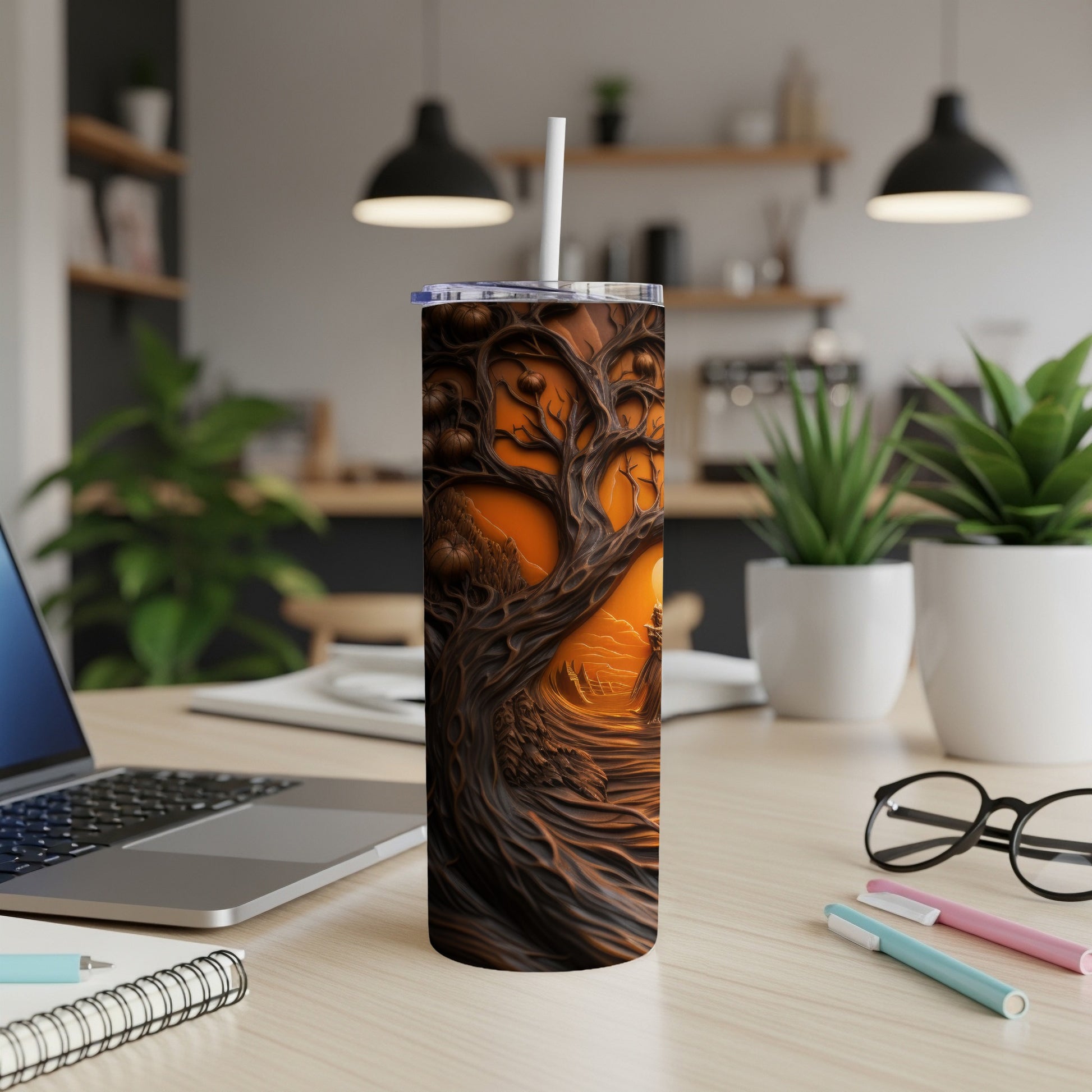 Tumbler with a spooky, gnarled tree and pumpkins under an orange sky.