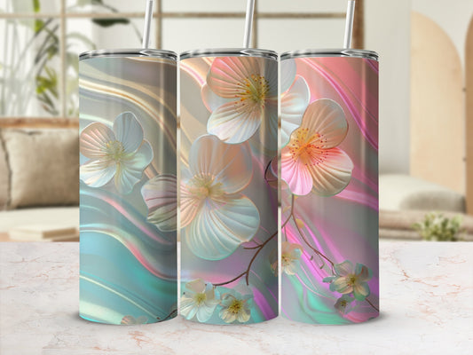 Three tall tumblers with iridescent floral designs and straws.