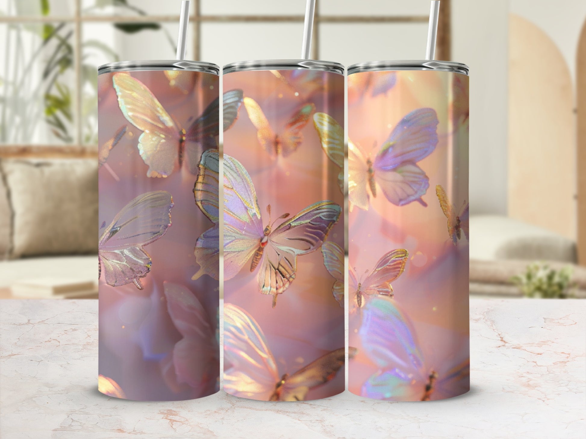 Three tumblers with iridescent butterfly patterns on a marbled surface.
