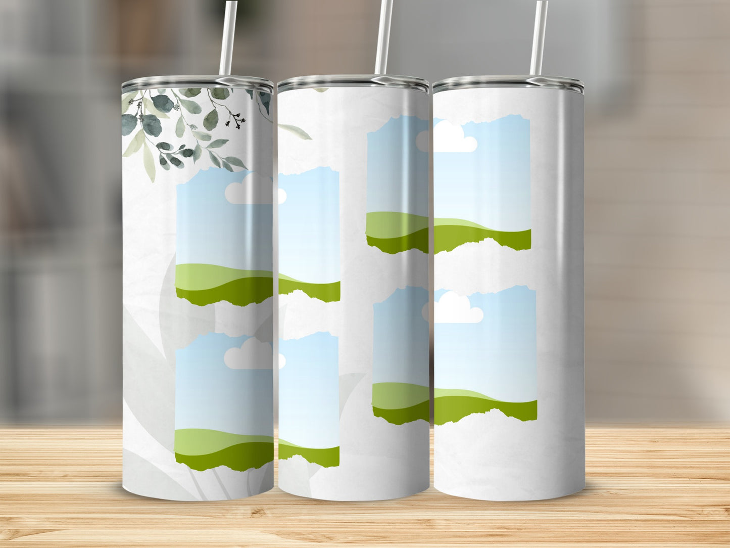 Three tumblers with green foliage and sky landscape designs.