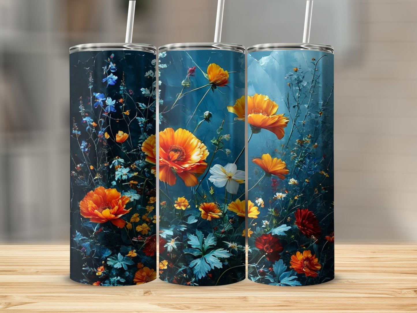 Three tall tumblers with vibrant orange and red wildflowers on a dark blue background.