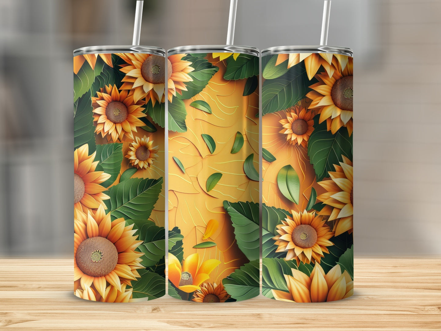 Three tumblers with sunflower and green leaf pattern on textured background.