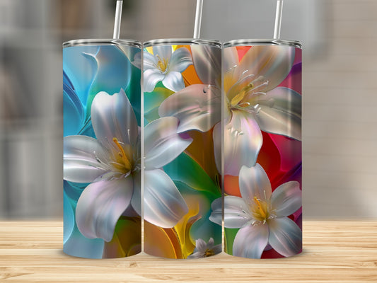 Three tumblers with vibrant floral designs featuring white lilies on a wooden surface.