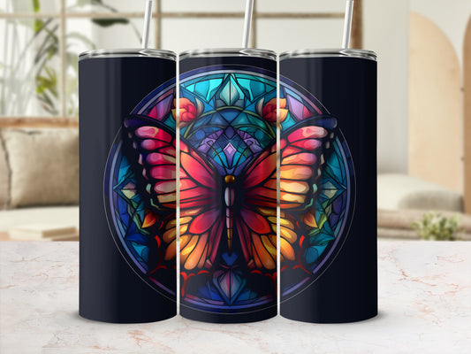 Dark tumbler with stained glass butterfly design and straw.