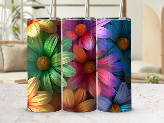 Three colorful tumblers with floral designs on a patterned surface.