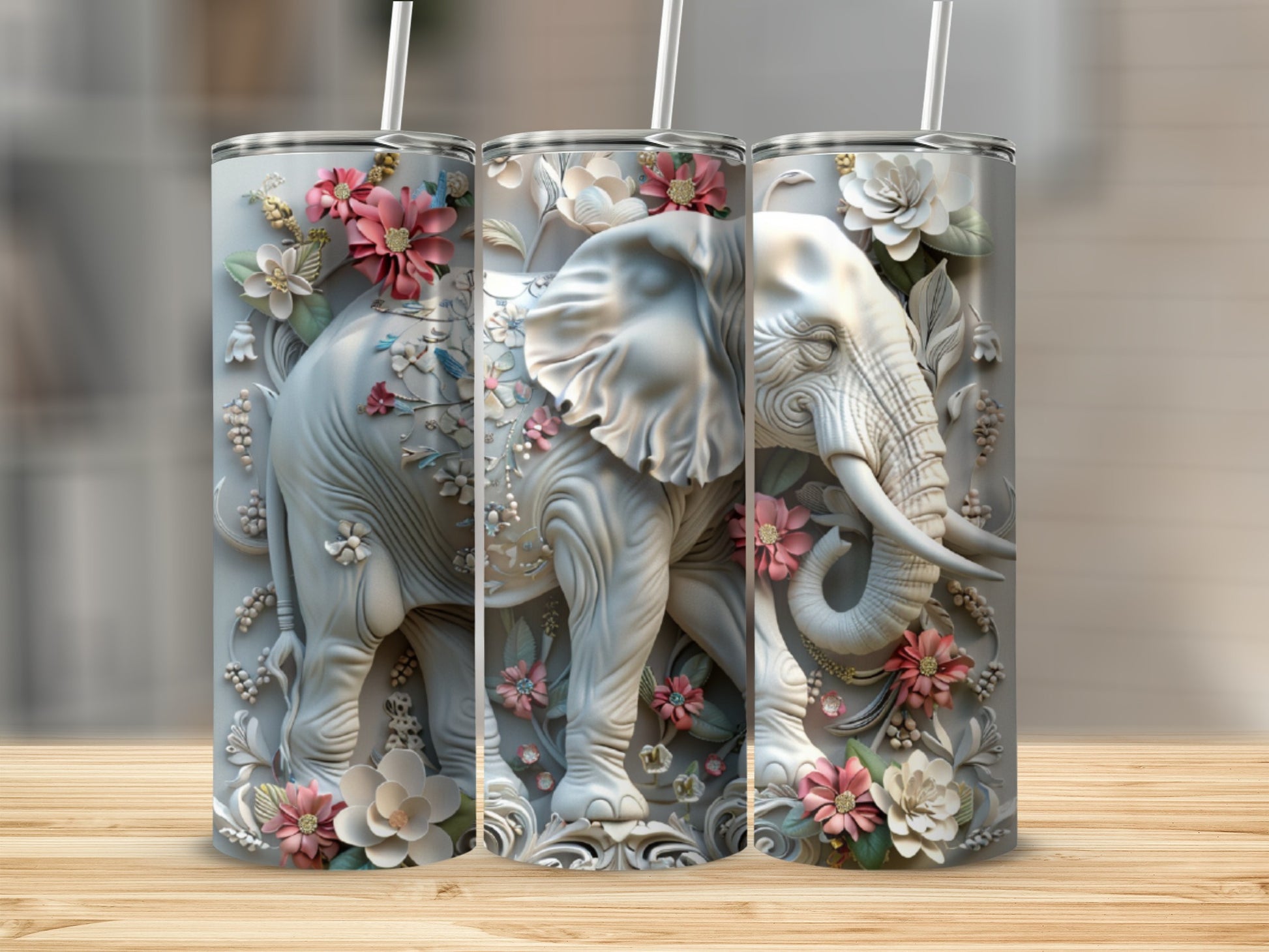 3D embossed elephant with floral accents on a grey tumbler with straw.