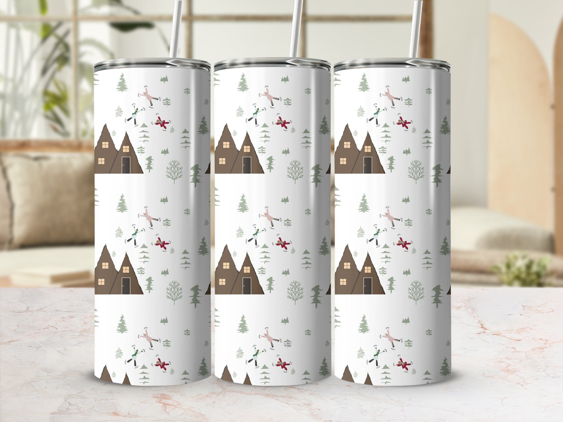 Three tumblers with a snowy cabin and tree design, one with a straw.