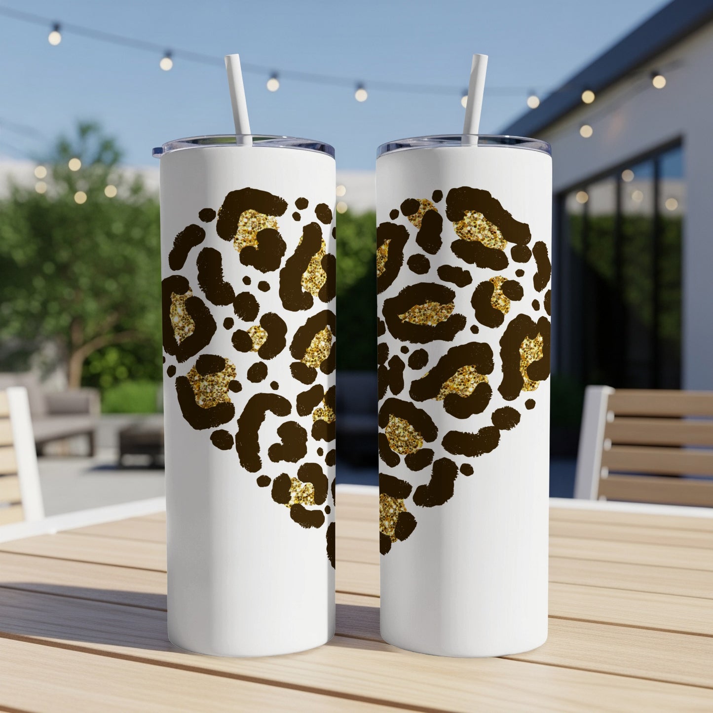 Two white tumblers with leopard print hearts and gold glitter accents.