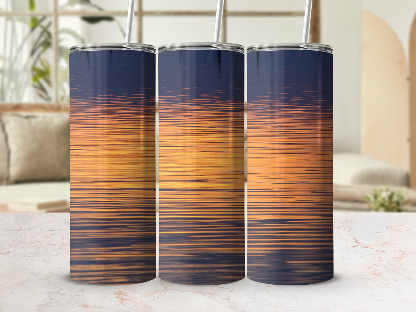 Three tumblers display a sunset reflection on water.