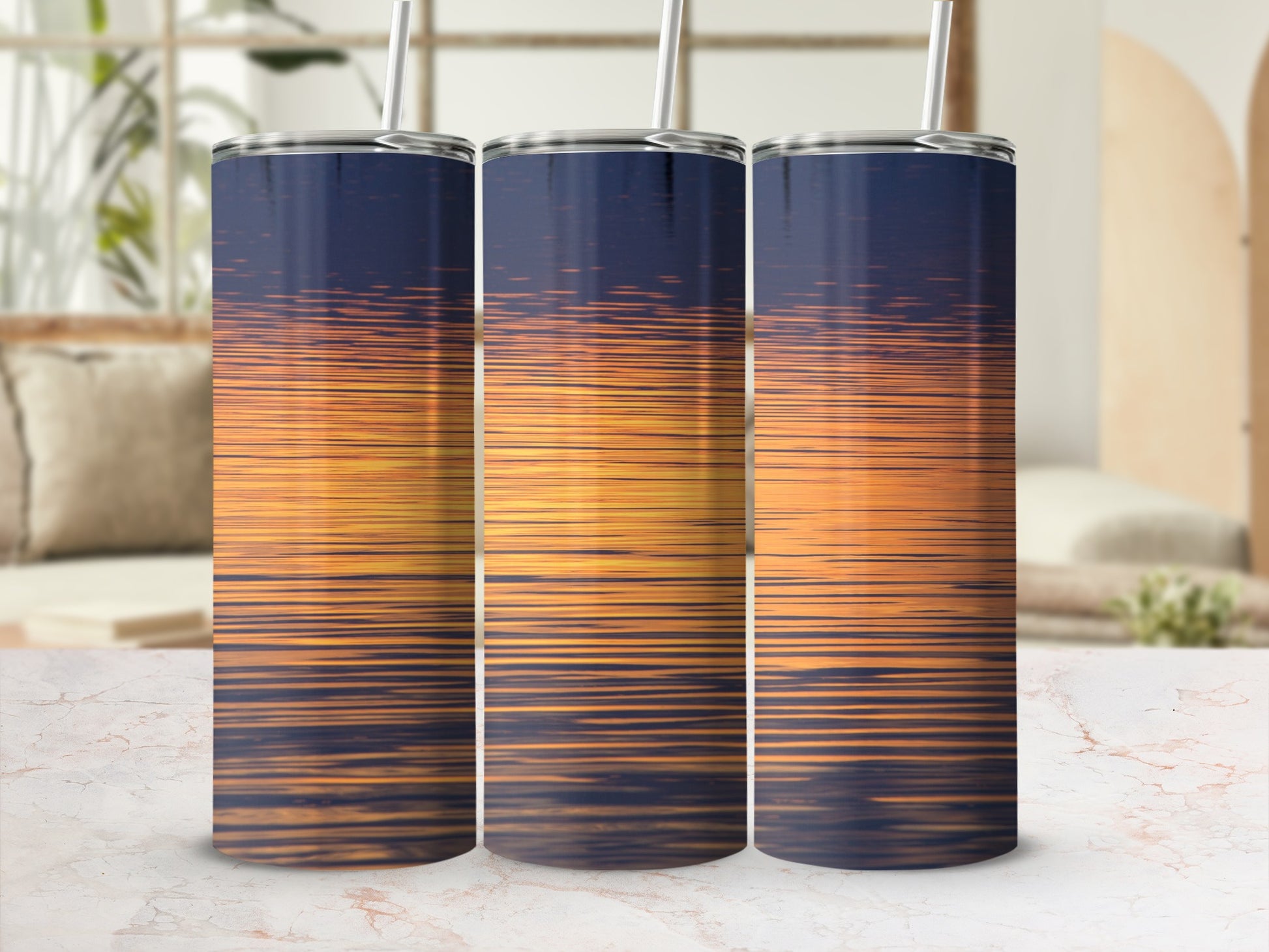 Three tumblers display a sunset reflection on water.