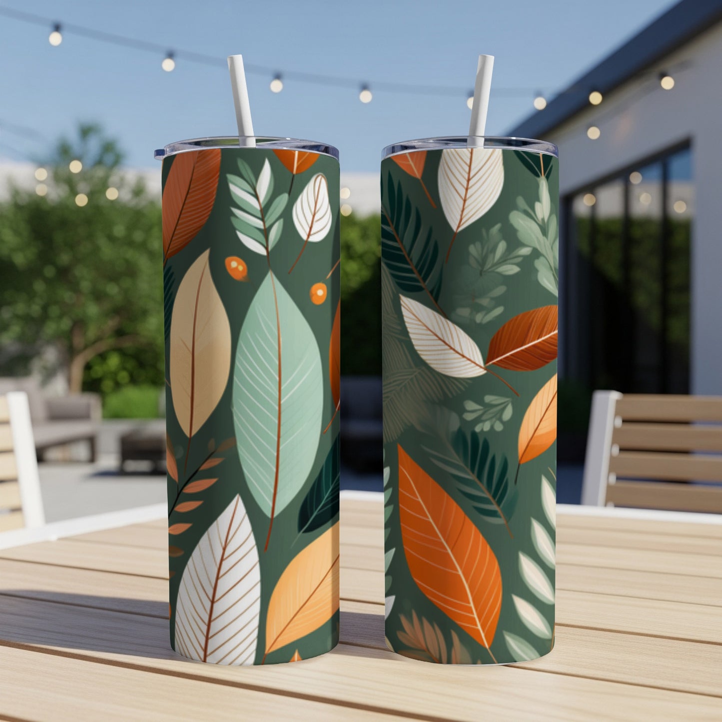Two green tumblers with a leaf pattern, placed on a wooden table.