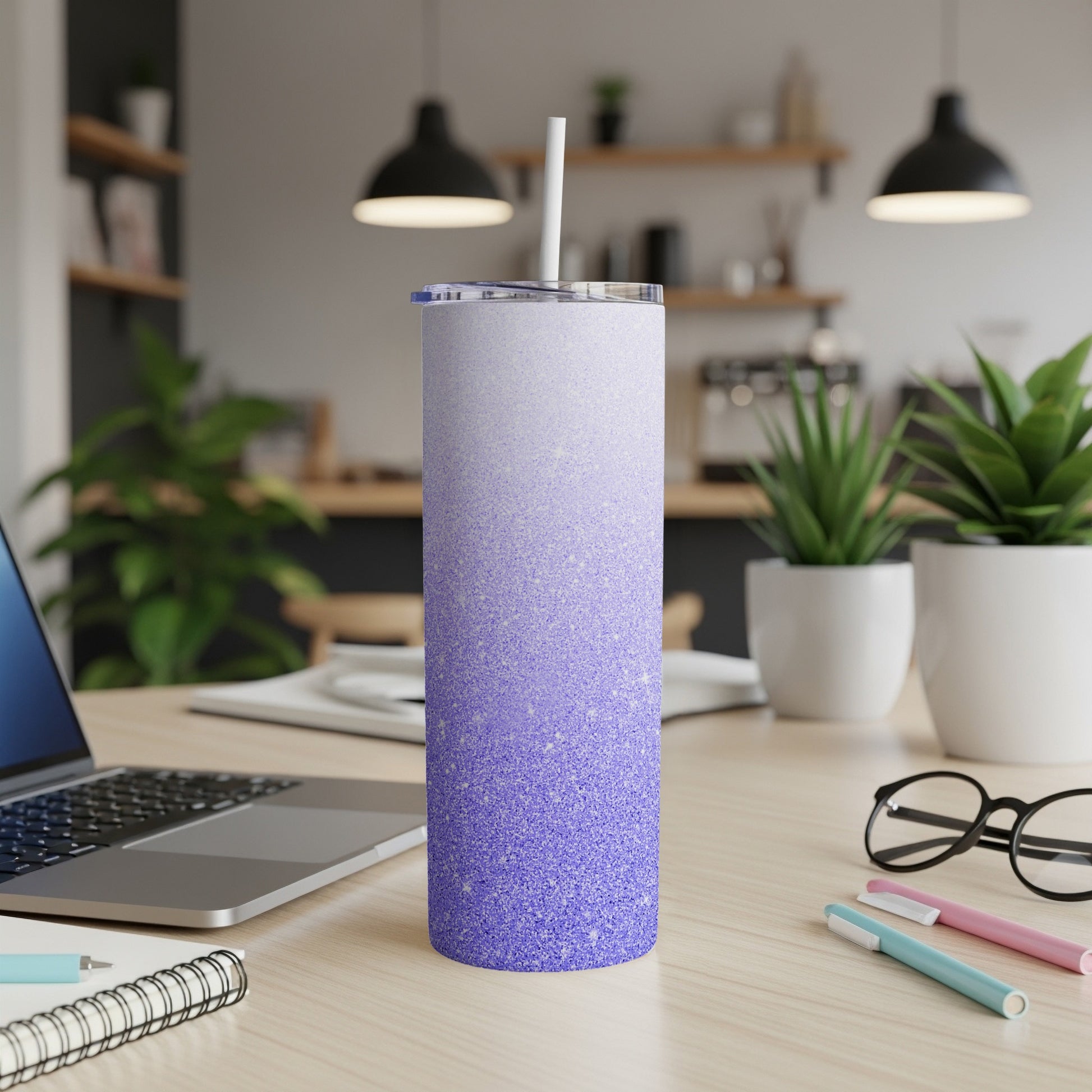 Purple glitter ombre tumbler with white straw on desk.