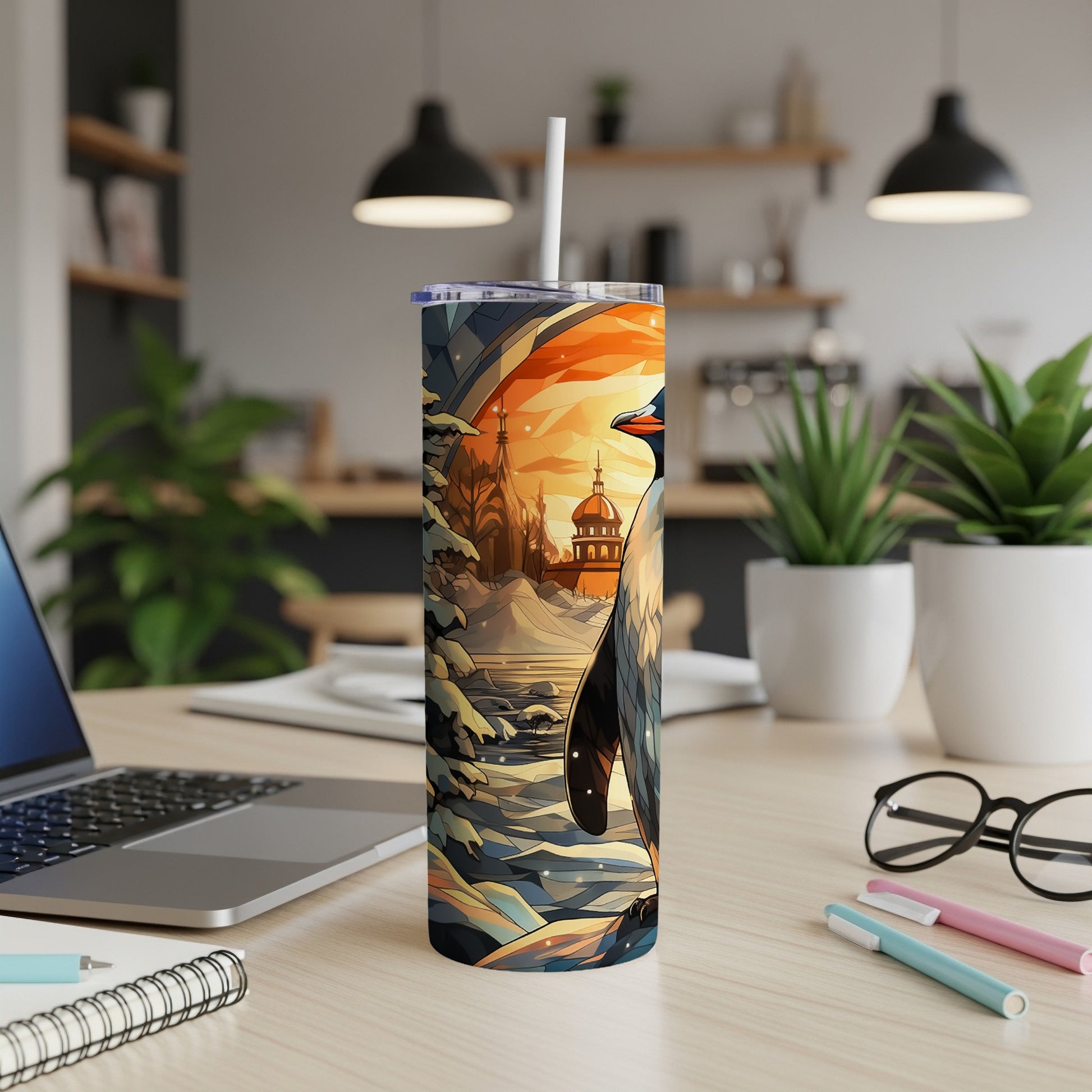 Penguin in a snowy landscape on a colorful tumbler with a straw.