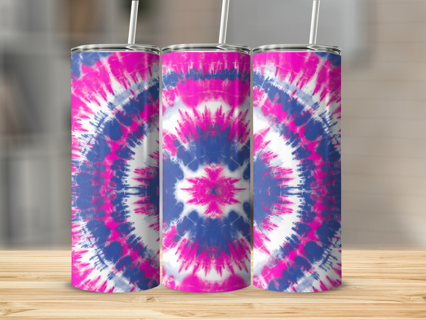 Three tumblers with pink, blue, and white tie-dye pattern on a wooden surface.