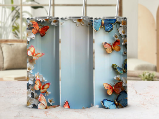 Blue and orange butterflies with white flowers on a gradient blue and white tumbler.