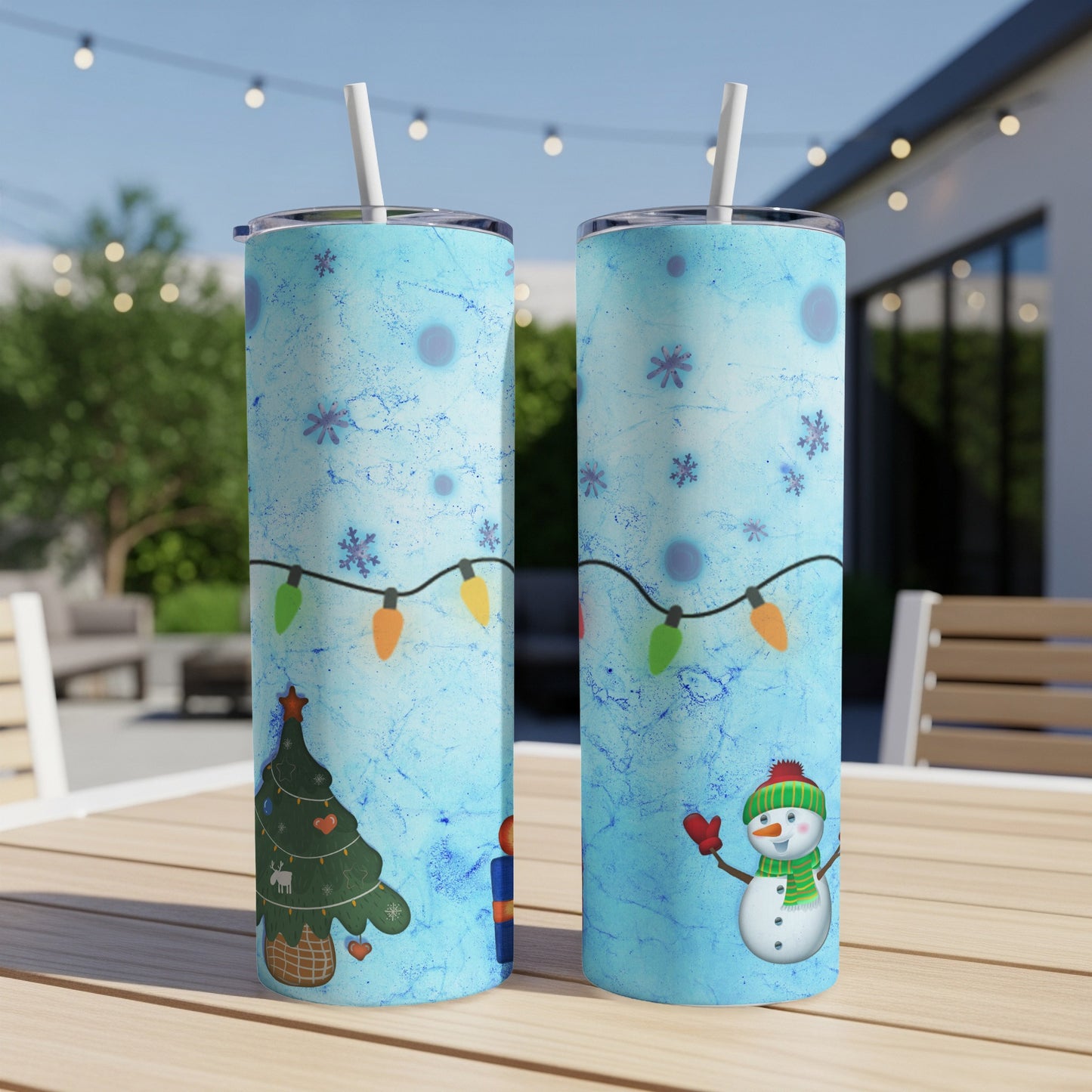 Blue tumbler with snowman, Christmas tree, and string lights pattern.