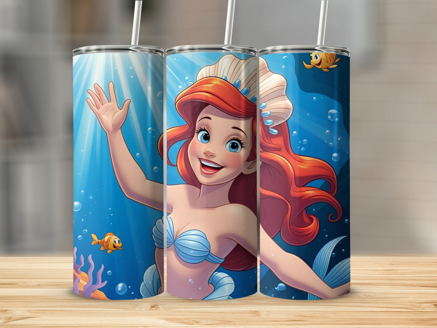 Ariel the mermaid smiles and waves from an underwater scene with fish.