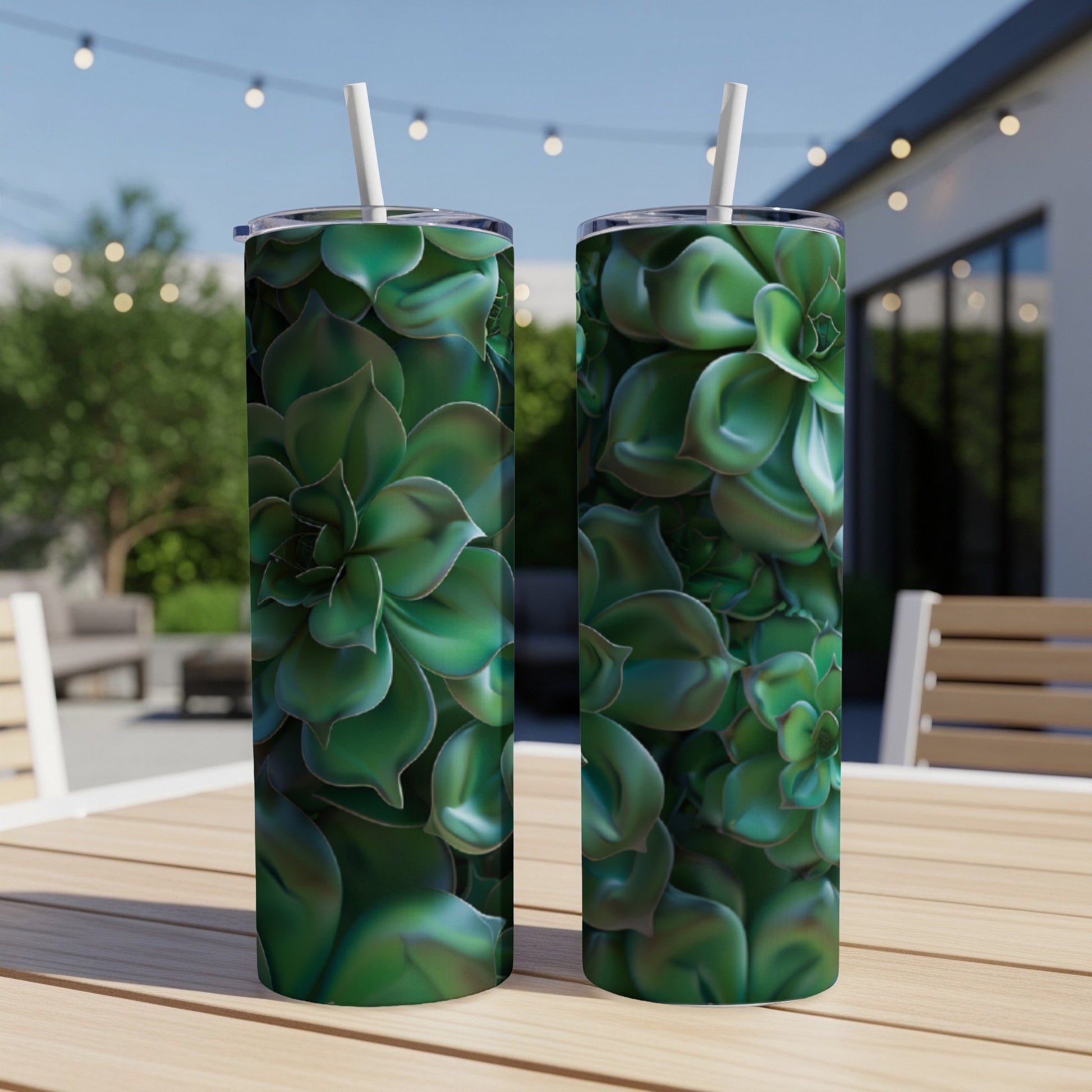 Two green succulent tumblers with straws on a wooden table outdoors.