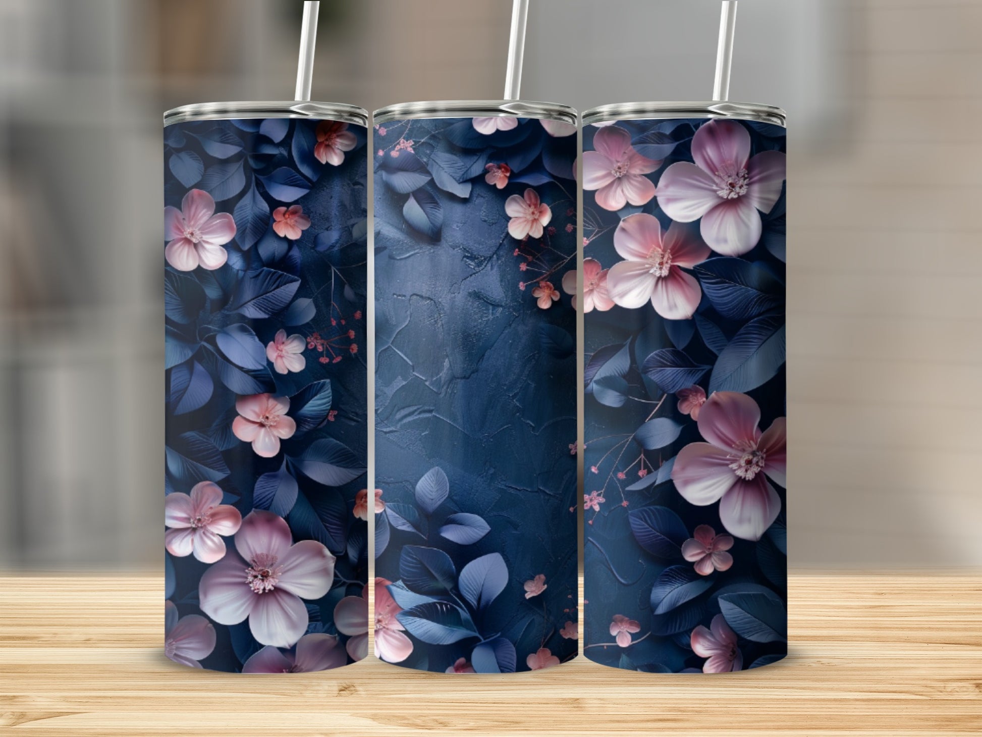 Three tumblers with a dark blue floral pattern and pink flowers.