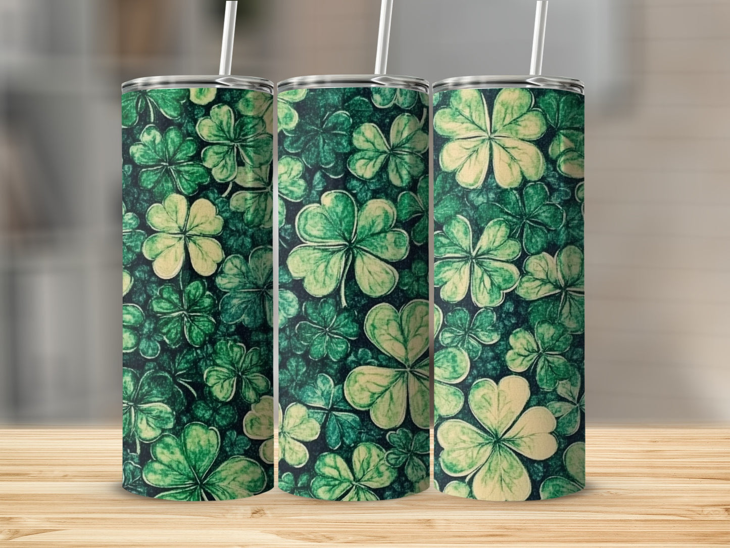 Three green tumblers with a repeating shamrock pattern.