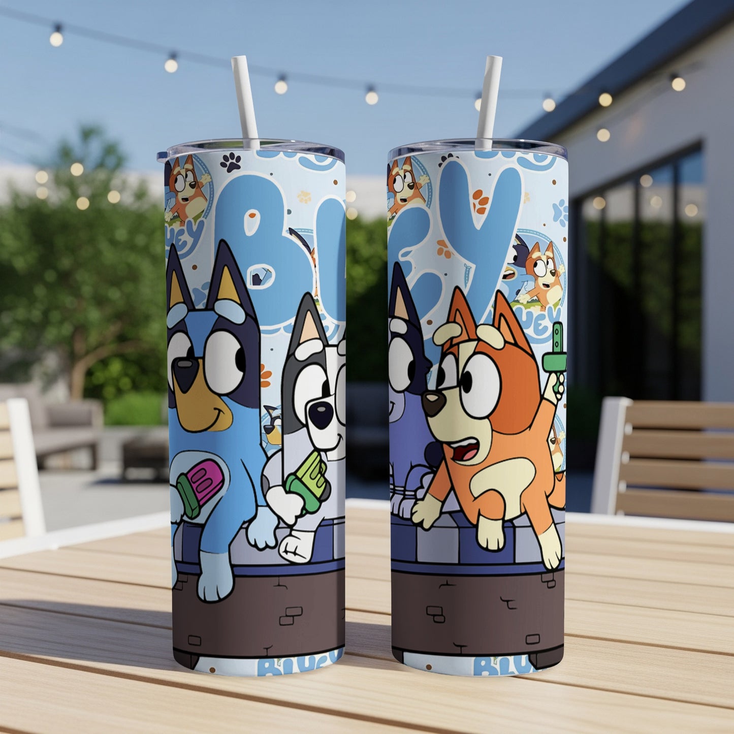 Bluey and Bingo characters on a blue and white patterned tumbler with straws.