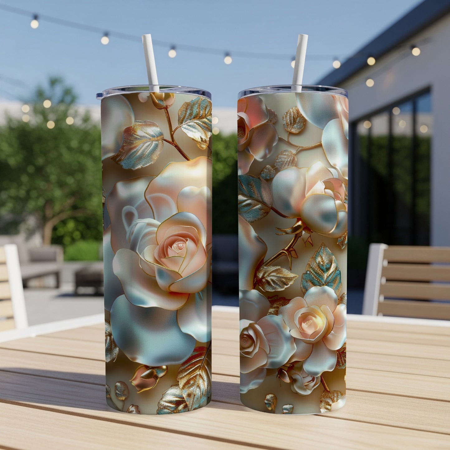 Two tumblers with rose floral design sit on a wooden table outdoors.